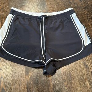 Black Athleta shorts with white stripes and elastic waist